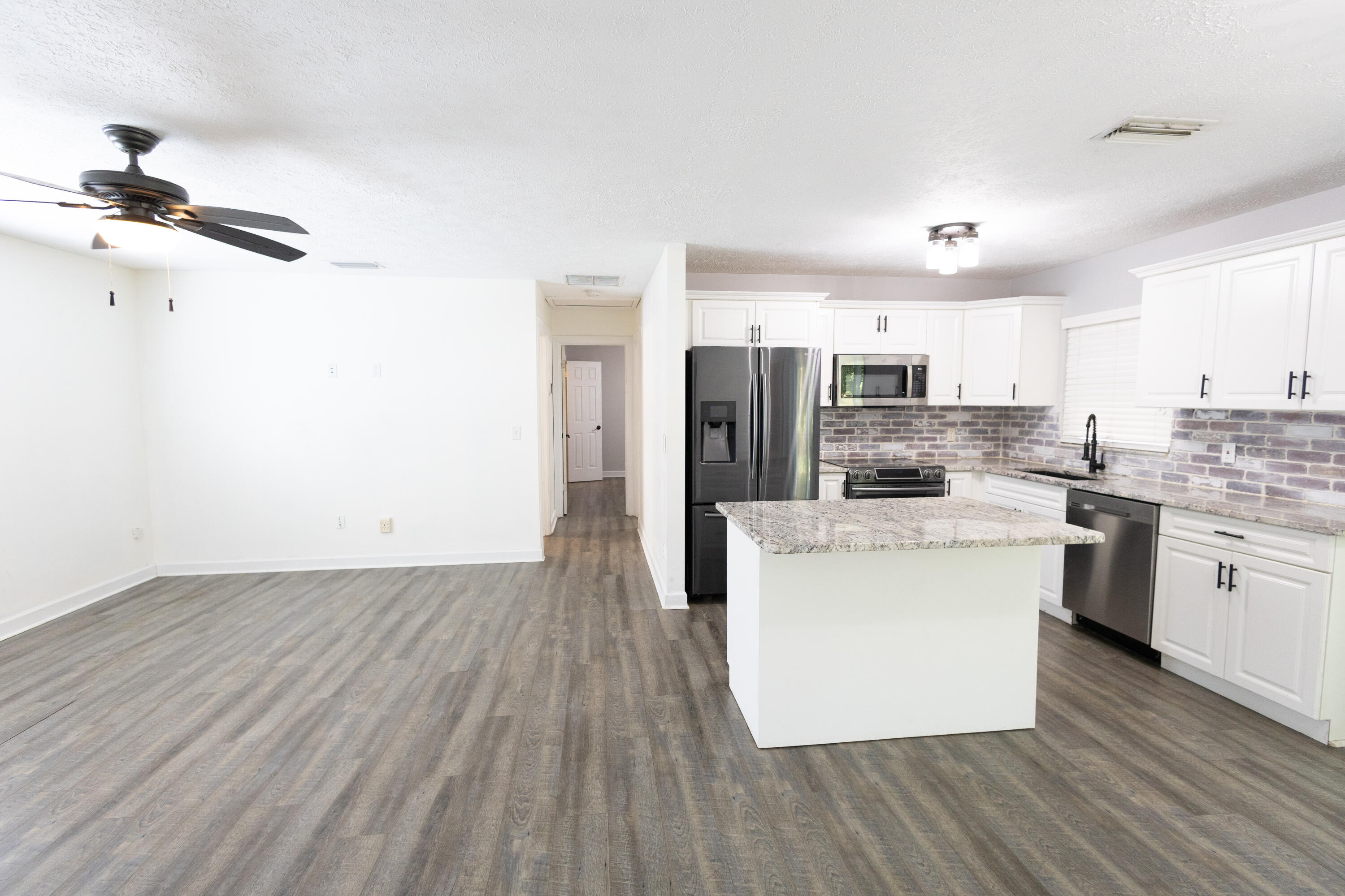 1914 Southwest Beauregard Street Port St. Lucie, FL 34953 - Photo 8 of 23 a kitchen with cabinets and wooden floor