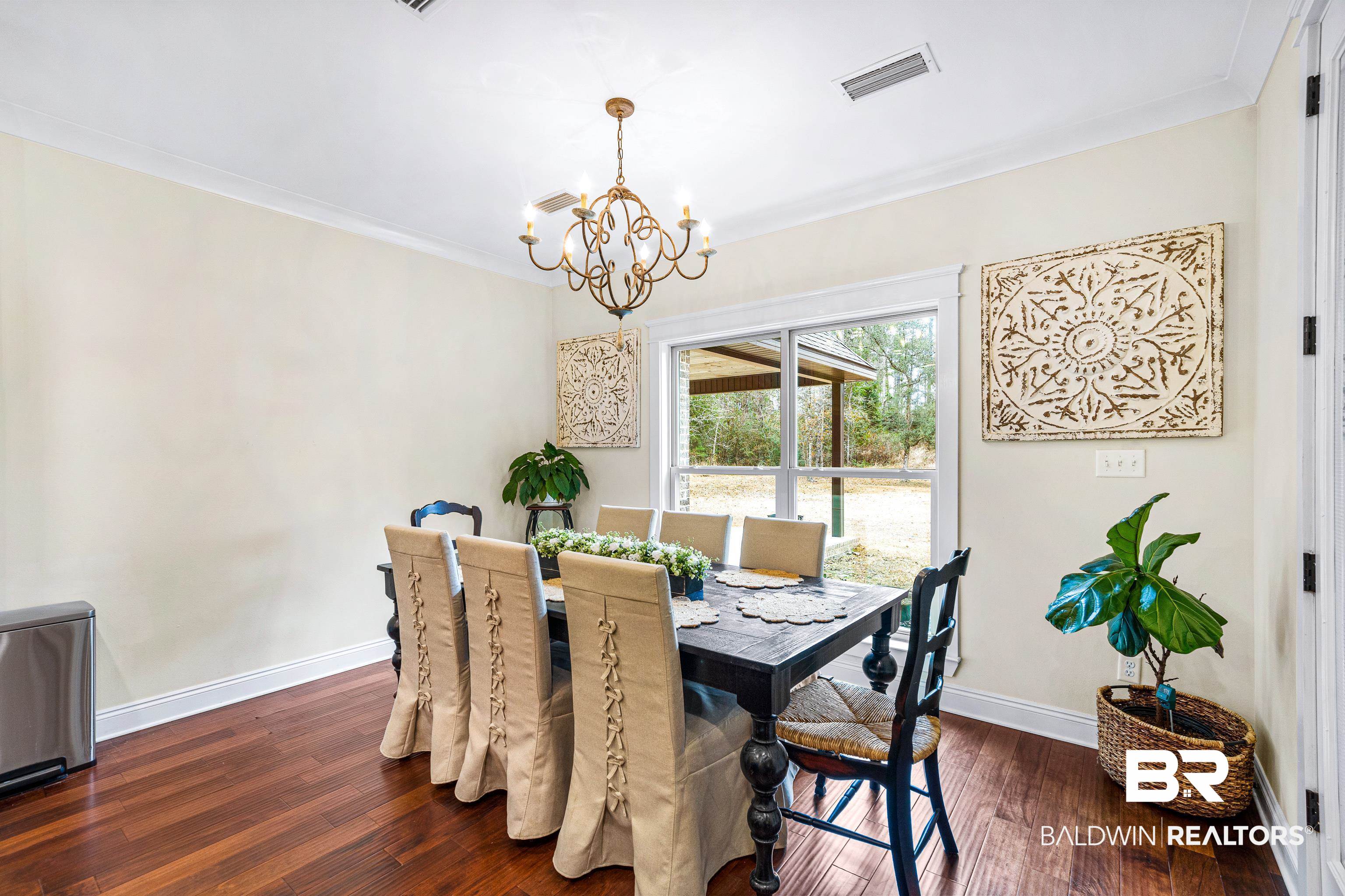 36784 Legacy Way Bay Minette, AL 36507 - Photo 17 of 57 Dining space featuring ornamental molding, an inviting chandelier, and dark hardwood / wood-style flooring