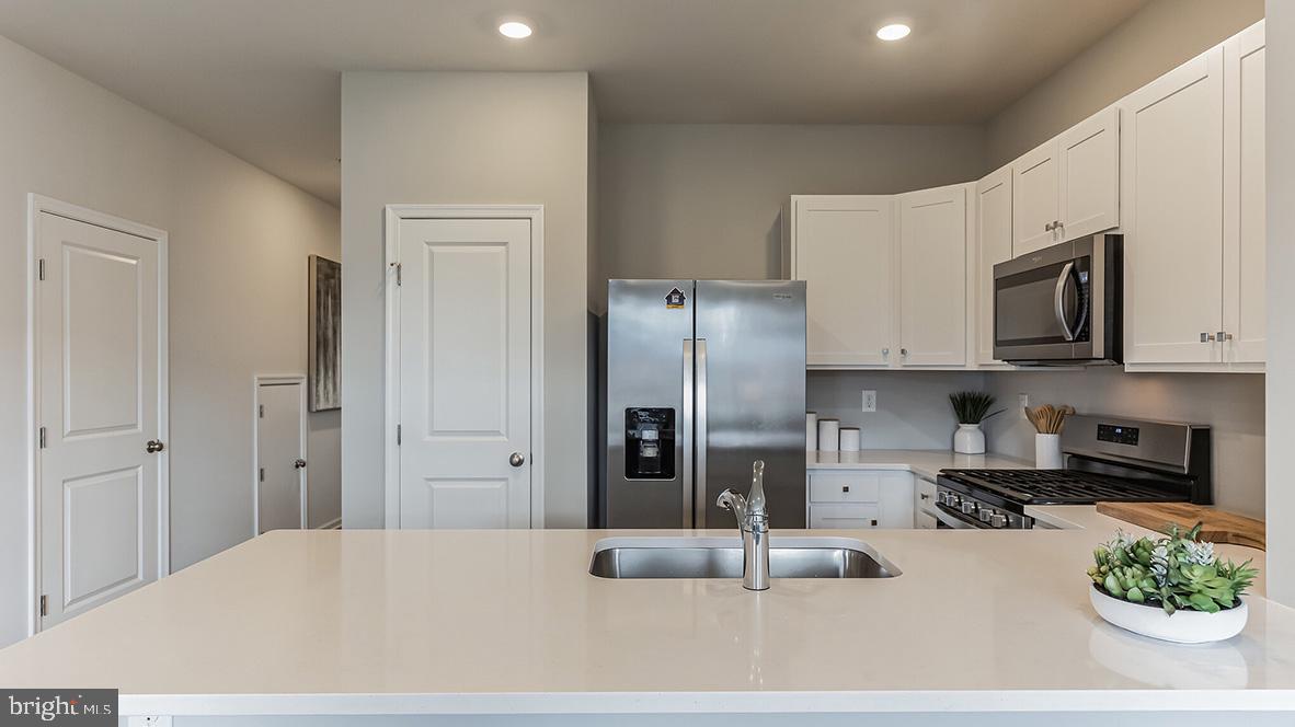 1162 Martin Road Breinigsville, PA 18031 - Photo 12 of 25 a kitchen with stainless steel appliances kitchen island granite countertop a refrigerator and microwave