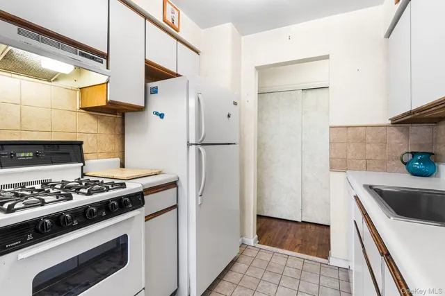 a kitchen with stainless steel appliances a stove and a refrigerator