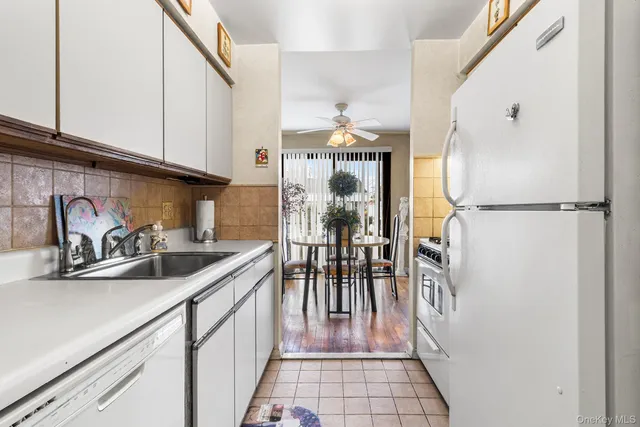 a bathroom with a sink a toilet and shower curtain