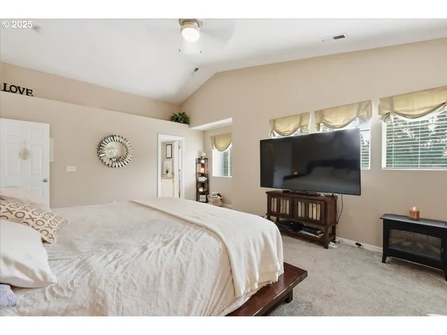 a bedroom with a bed and a flat screen tv