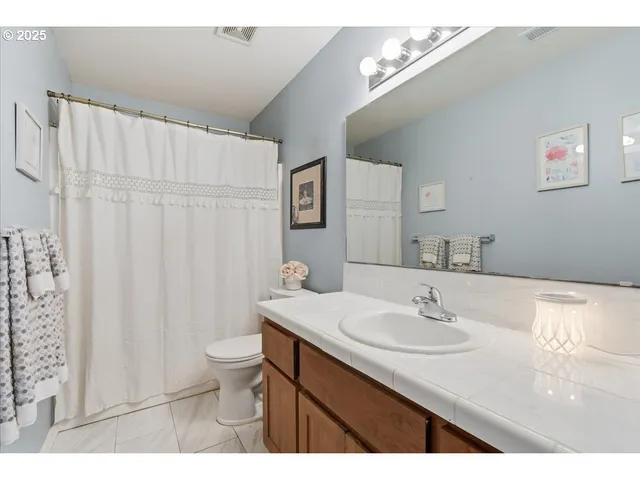 a living room with furniture a flat screen tv and a window