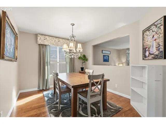 a view of a dining room with furniture and chandelier