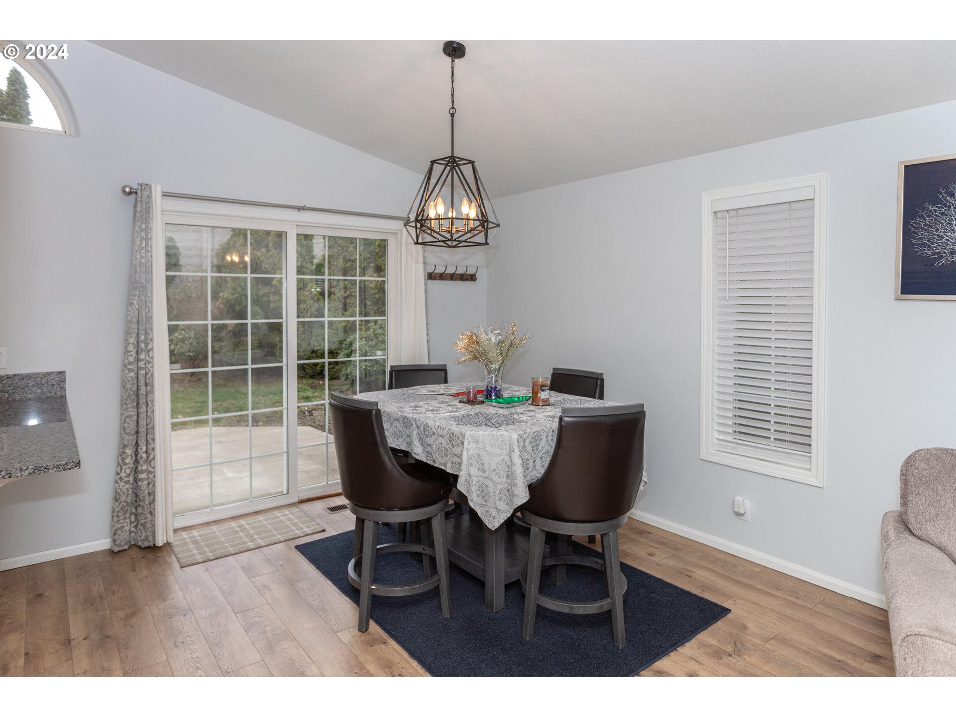 1690 Ridgley Boulevard Eugene, OR 97401 - Photo 12 of 30 a dining room with furniture a chandelier and wooden floor