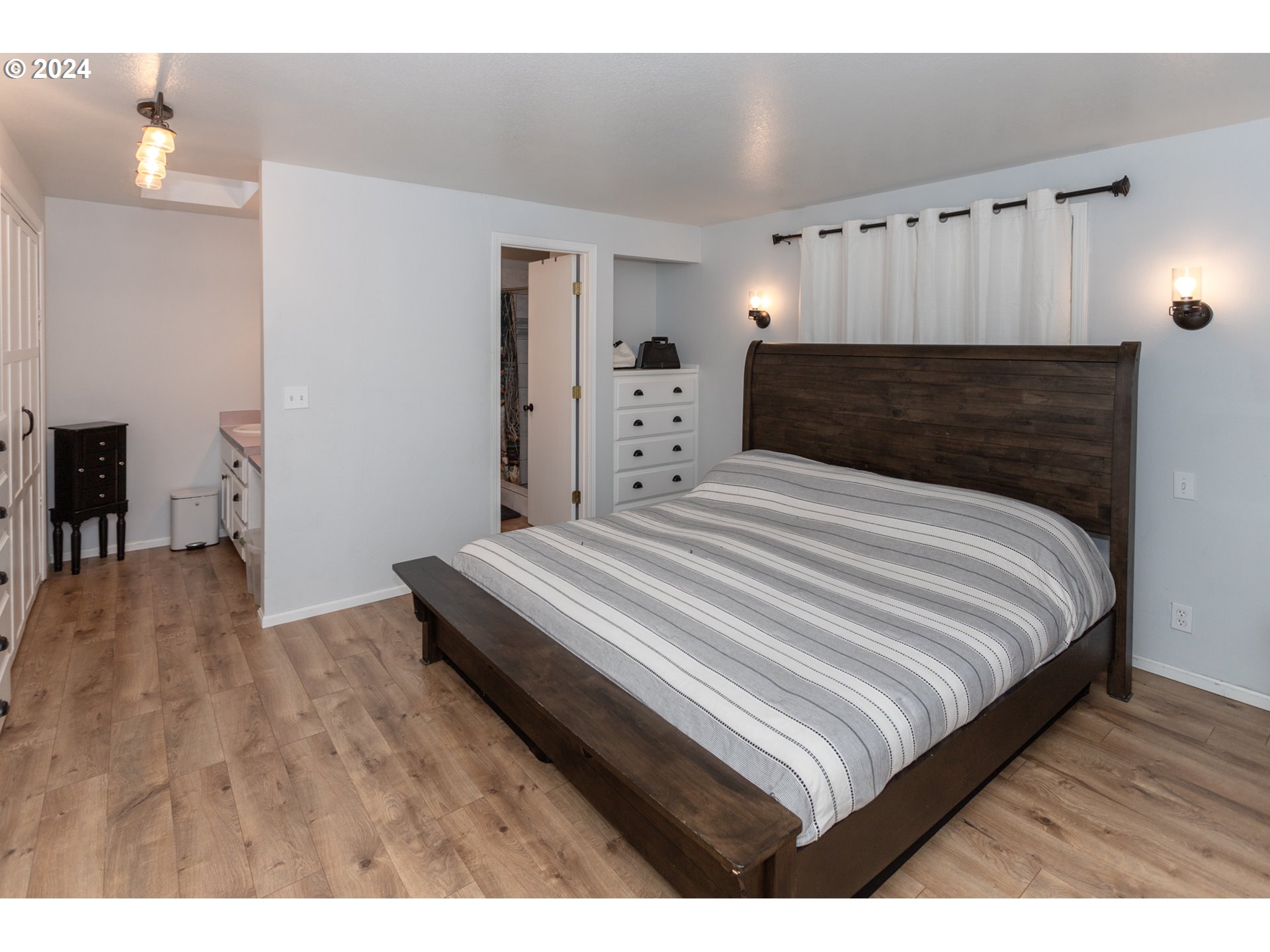 1690 Ridgley Boulevard Eugene, OR 97401 - Photo 21 of 30 a bedroom with a bed and wooden floor
