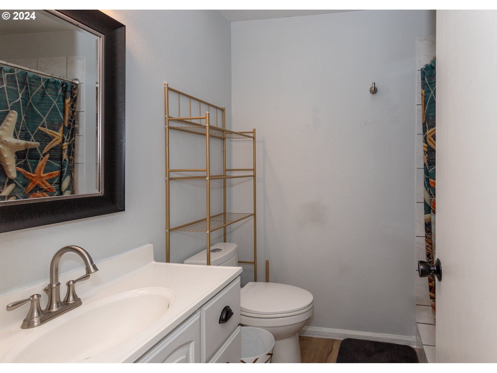1690 Ridgley Boulevard Eugene, OR 97401 - Photo 25 of 30 a bathroom with a sink a toilet and mirror