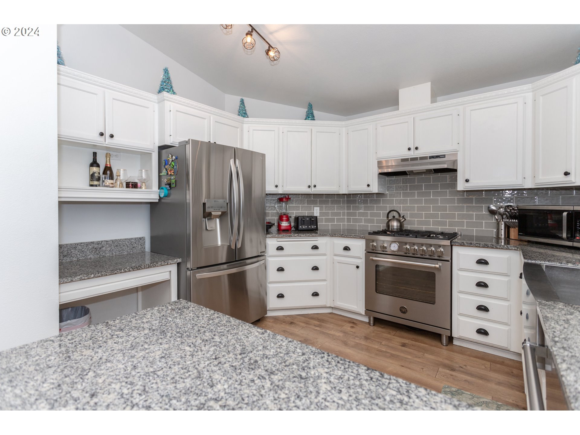 1690 Ridgley Boulevard Eugene, OR 97401 - Photo 9 of 30 a kitchen with stainless steel appliances a stove a refrigerator and cabinets