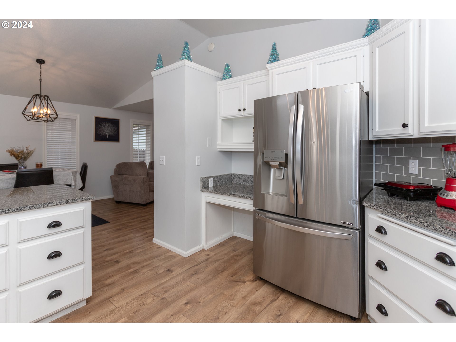 1690 Ridgley Boulevard Eugene, OR 97401 - Photo 10 of 30 a kitchen with stainless steel appliances white cabinets and wooden floor