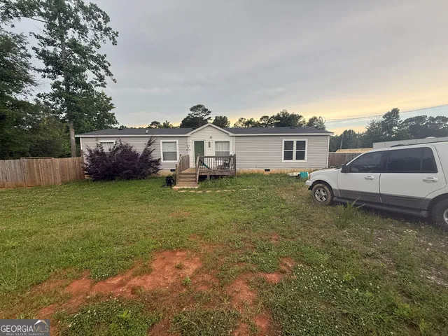 a view of a house with a yard and sitting area