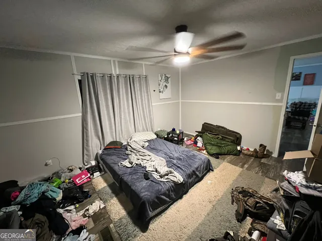 a bedroom with bed and a chandelier