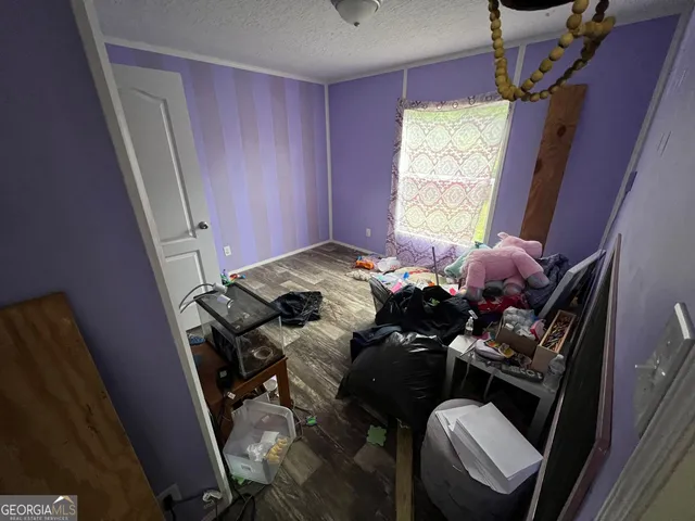 a bed sitting in a bedroom next to a window