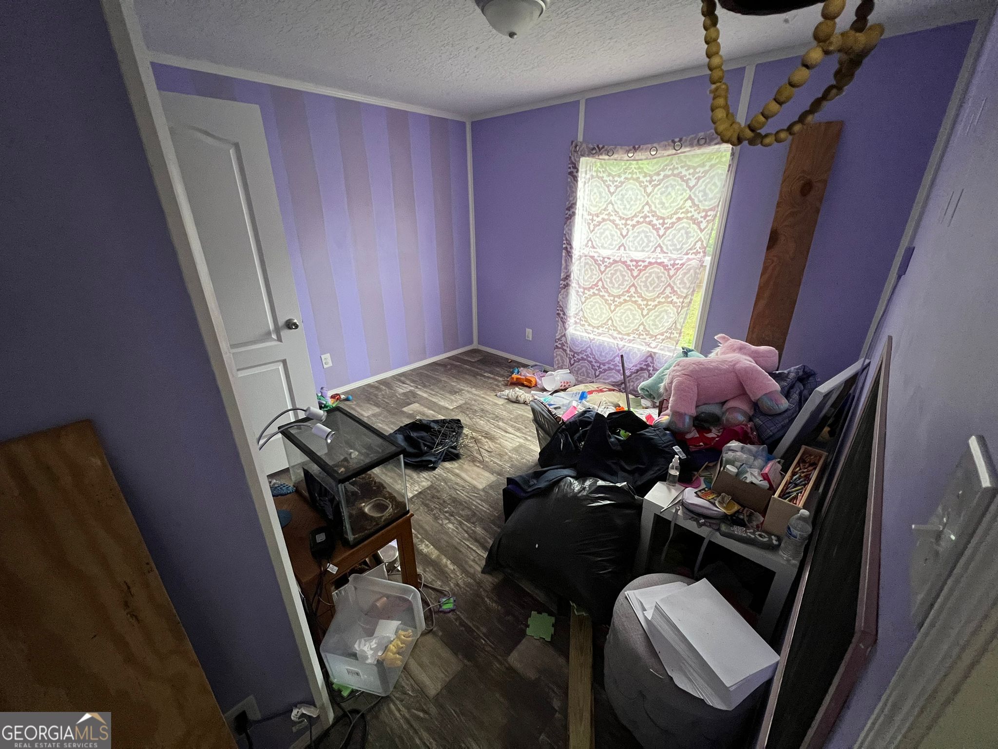 126 Southgate Road Alto, GA 30510 - Photo 7 of 14 a bed sitting in a bedroom next to a window