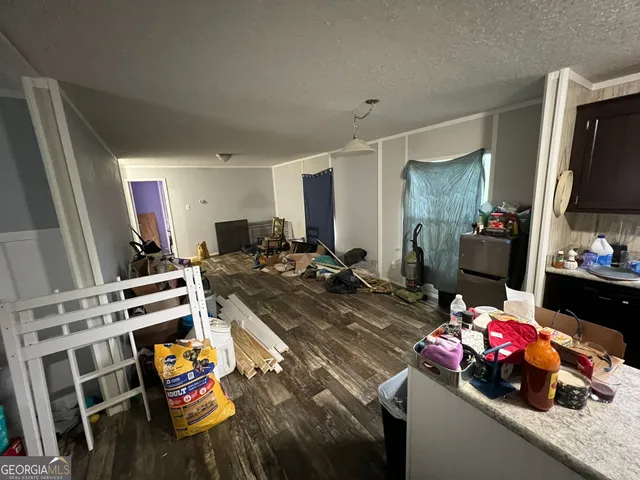 a view of a kitchen with furniture and clutter