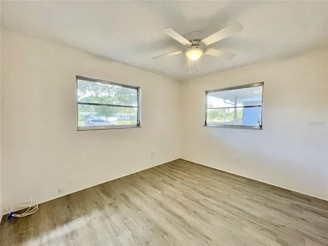 wooden floor in an empty room with a window