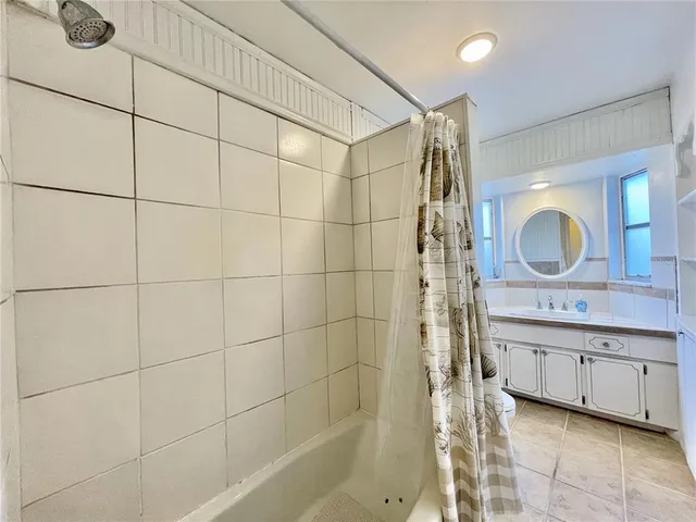 a bathroom with a double vanity sink a mirror and shower