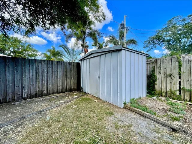 a view of a backyard with wooden fence