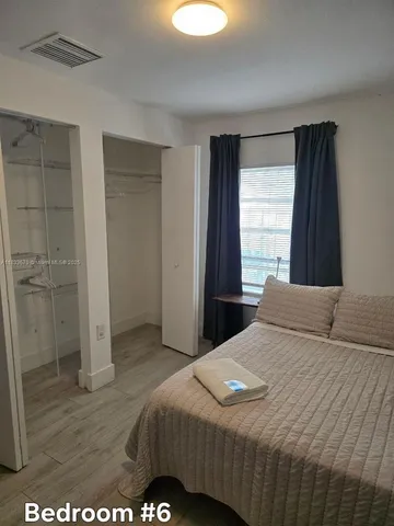 a bedroom with a bed and a view of bathroom