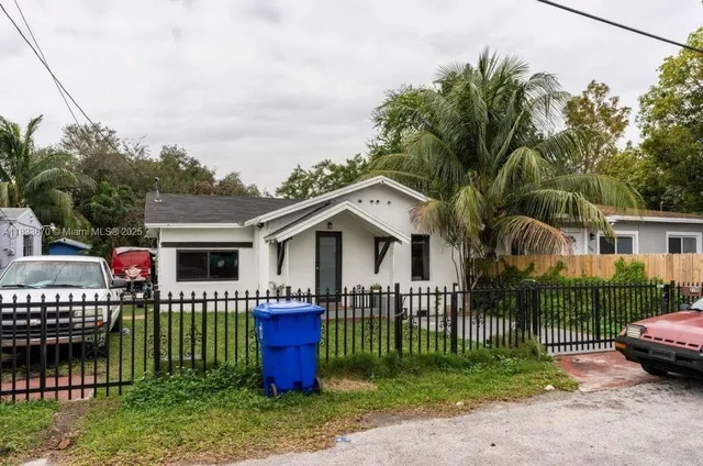 a front view of house with yard and outdoor seating