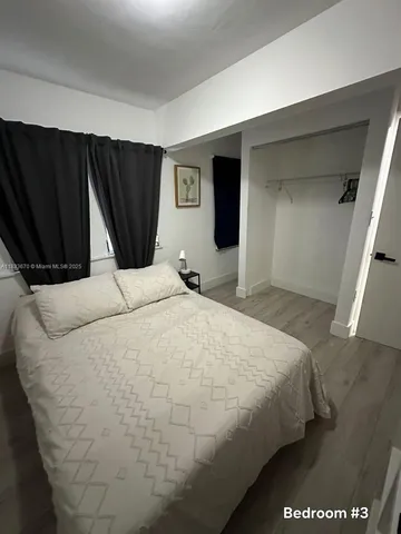 a bedroom with a bed and a mirror
