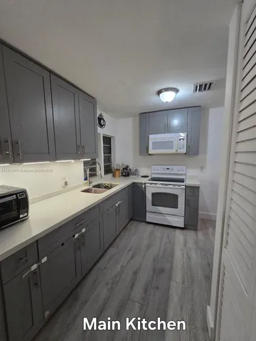 a kitchen with a sink cabinets and appliances