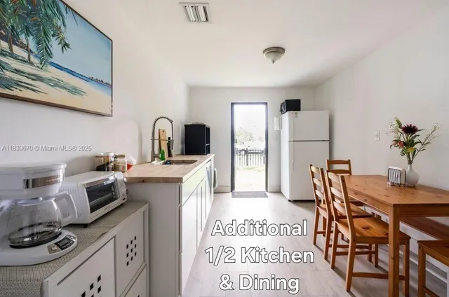 a kitchen with granite countertop a table and chairs