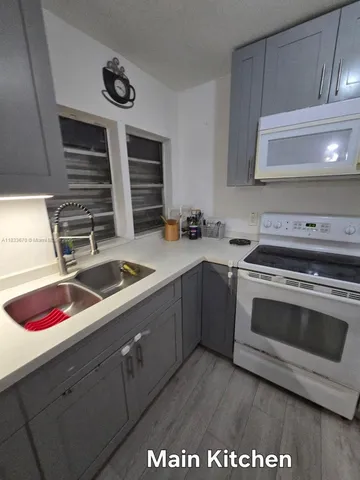 a kitchen with a sink and cabinets