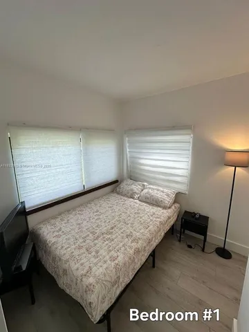 a bed sitting in a room next to a window