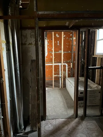 a bathroom with a tub mirror and sink