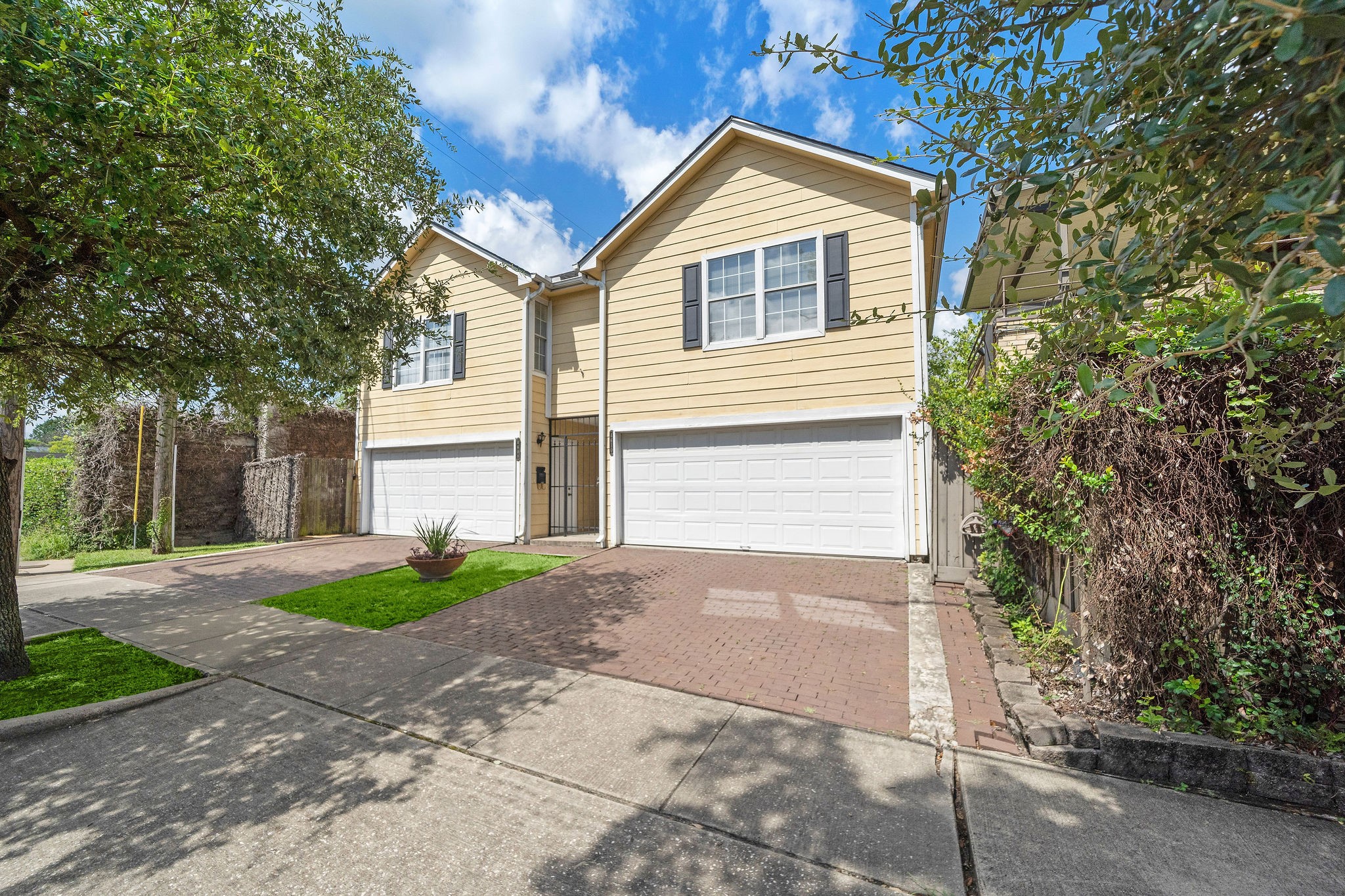 1801 Lexington Street Houston, TX 77098 - Photo 23 of 50 a front view of a house with a yard and a garage