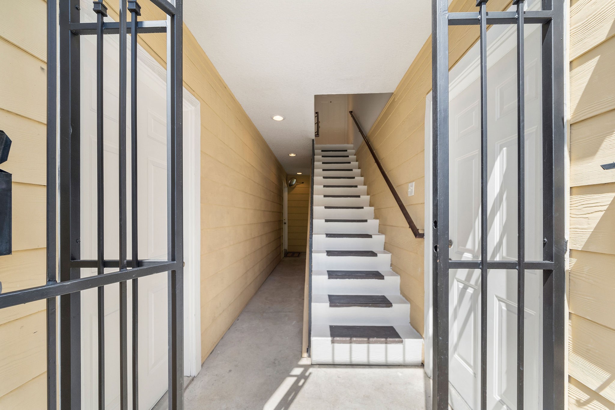 1801 Lexington Street Houston, TX 77098 - Photo 24 of 50 a view of staircase with lots of frames on wall and windows