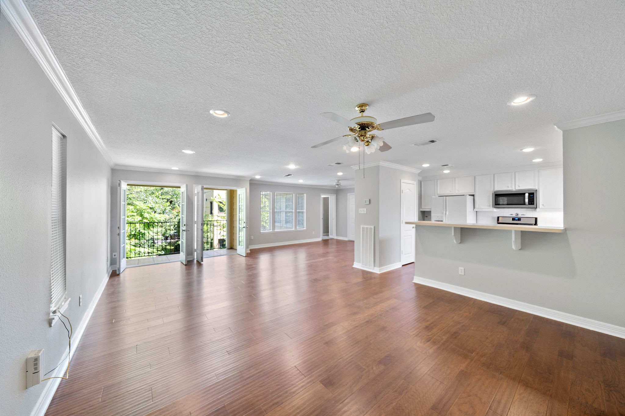 1801 Lexington Street Houston, TX 77098 - Photo 50 of 50 a view of an empty room with wooden floor and a kitchen