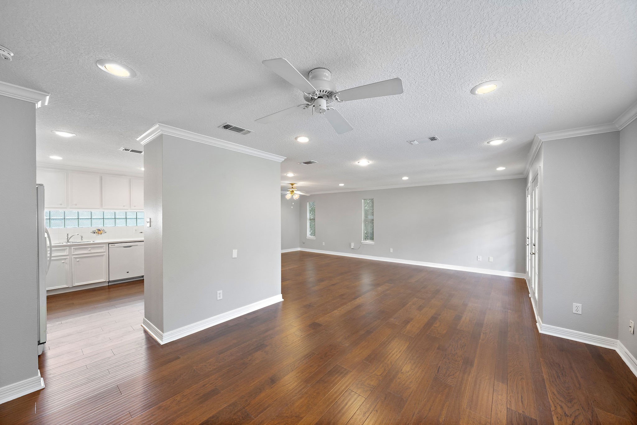 1801 Lexington Street Houston, TX 77098 - Photo 29 of 50 a view of an empty room and kitchen with wooden floor