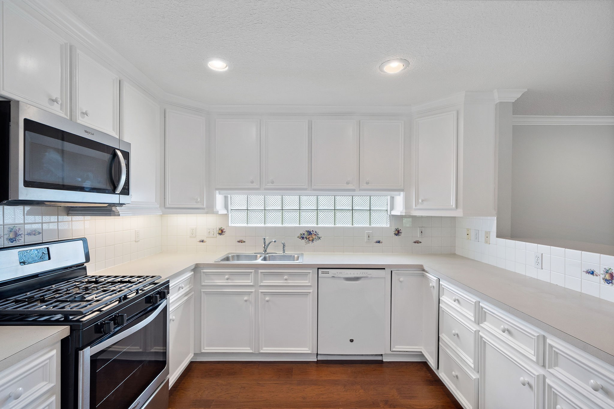 1801 Lexington Street Houston, TX 77098 - Photo 32 of 50 a kitchen with white cabinets sink and stainless steel appliances