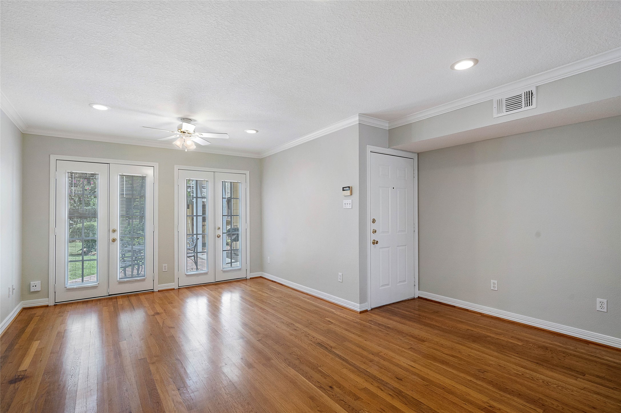 1801 Lexington Street Houston, TX 77098 - Photo 42 of 50 a view of an empty room with wooden floor and a window