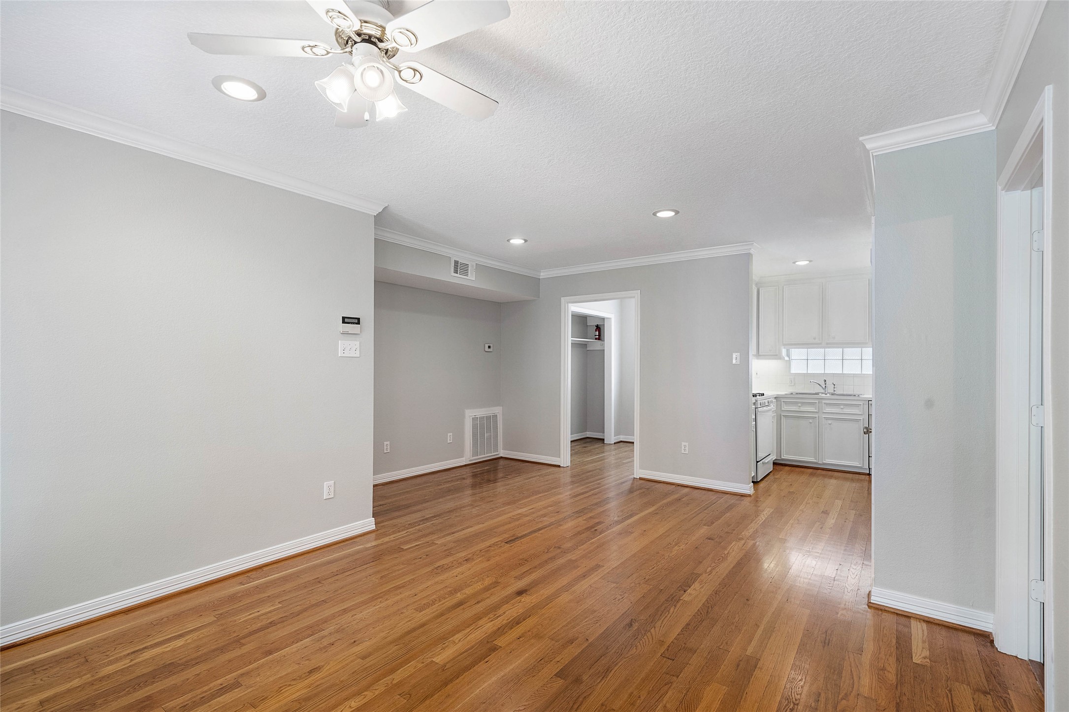 1801 Lexington Street Houston, TX 77098 - Photo 43 of 50 a view of an empty room with wooden floor and a ceiling fan