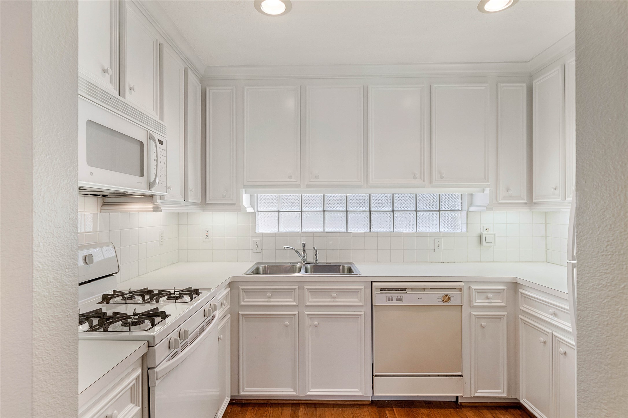 1801 Lexington Street Houston, TX 77098 - Photo 45 of 50 a kitchen with white cabinets and appliances