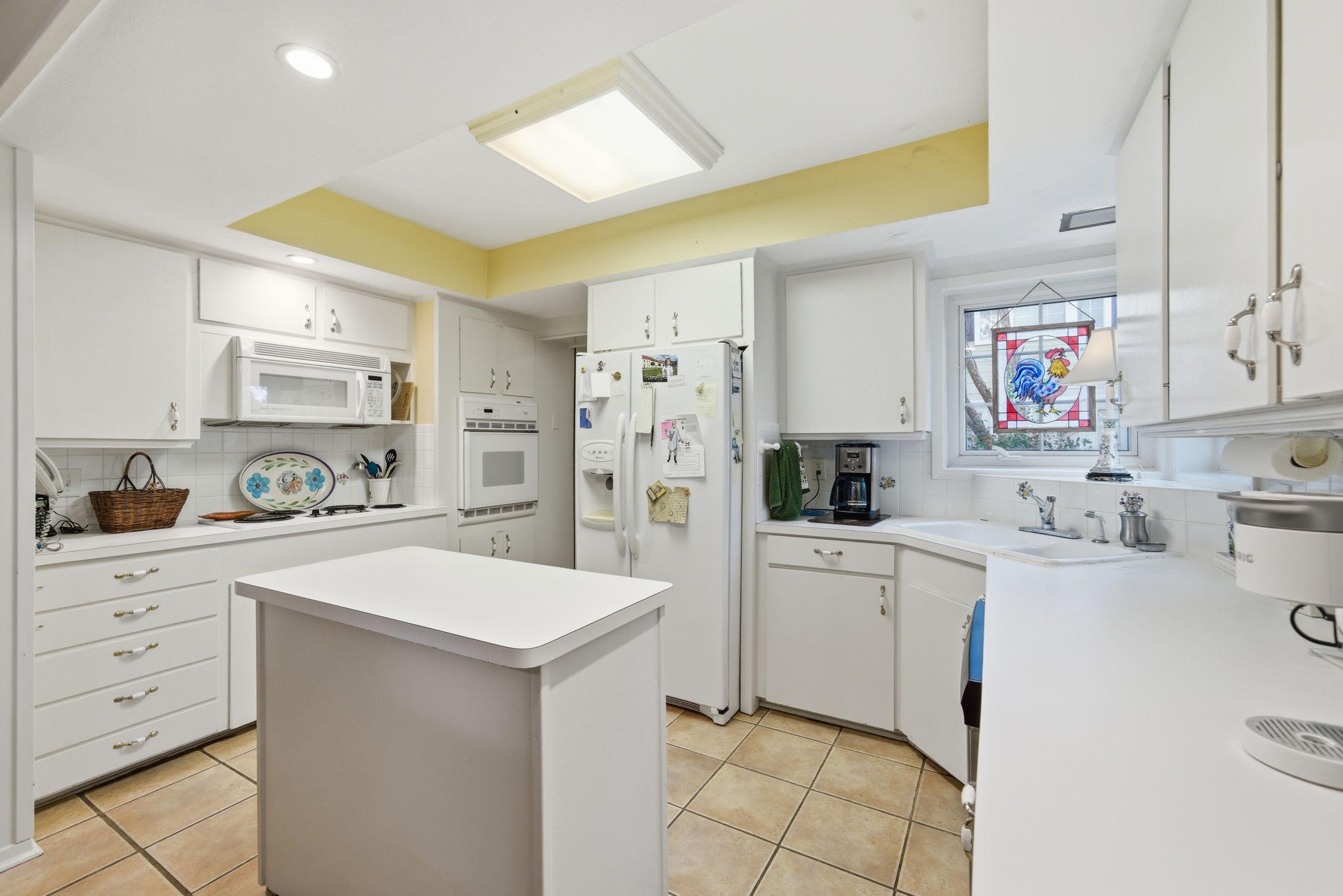 1801 Lexington Street Houston, TX 77098 - Photo 10 of 50 a kitchen with white cabinets and refrigerator