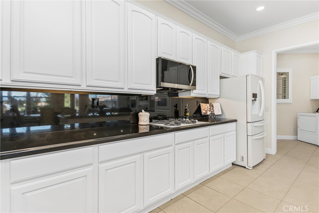 5233 Hampton Road Banning, CA 92220 - Photo 13 of 46 a kitchen with granite countertop white cabinets and stainless steel appliances