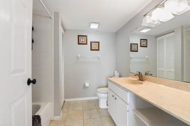 a bathroom with a double vanity sink a toilet and a mirror