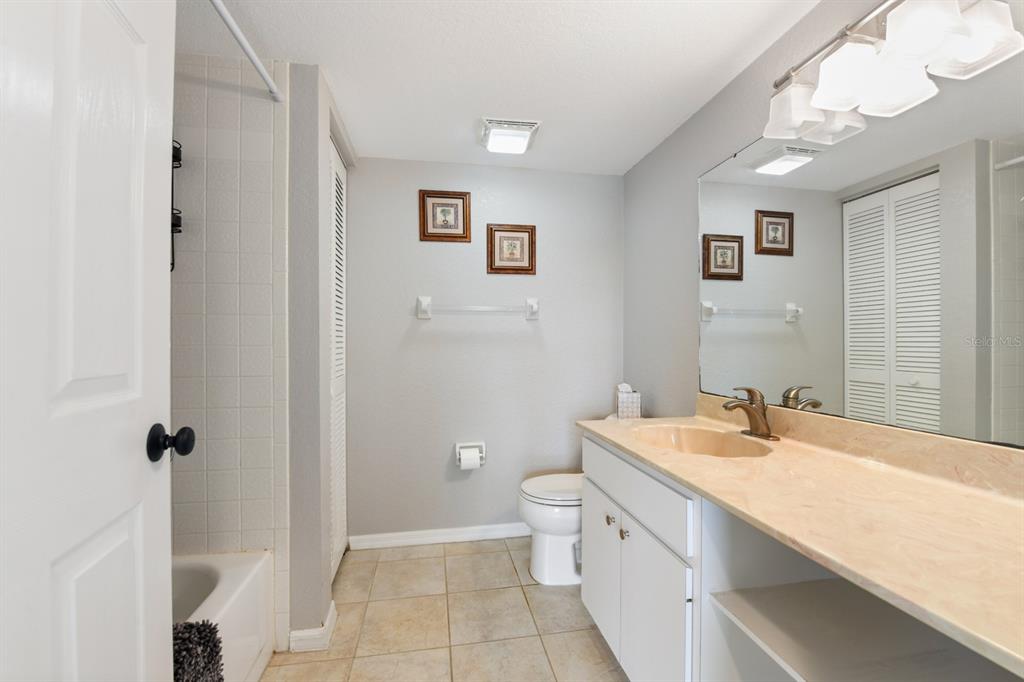 449 Royal Poinciana, Unit 221 Punta Gorda, FL 33955 - Photo 12 of 17 a bathroom with a double vanity sink a toilet and a mirror
