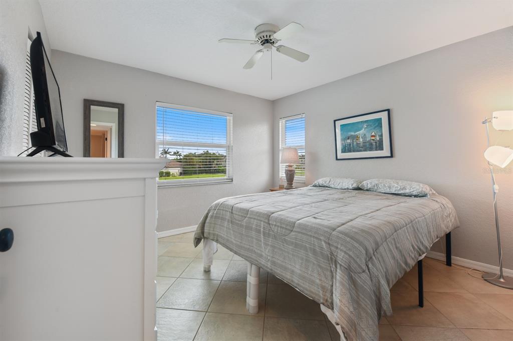 449 Royal Poinciana, Unit 221 Punta Gorda, FL 33955 - Photo 13 of 17 a bedroom with a bed and a chandelier