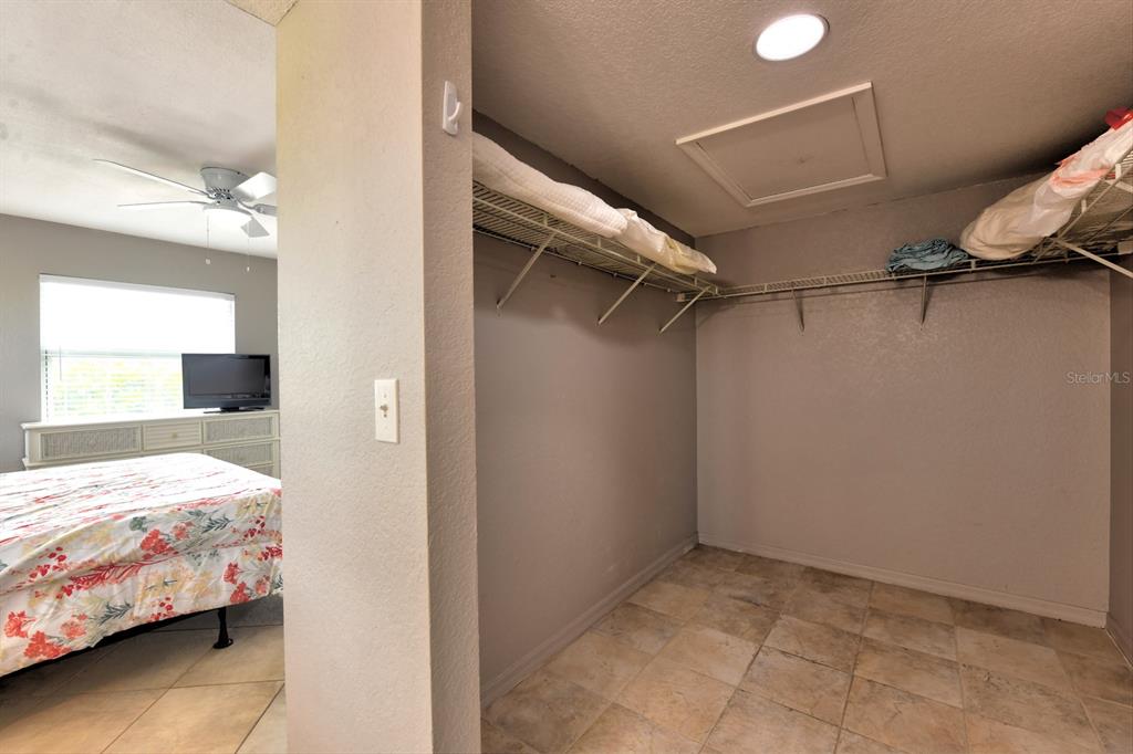 449 Royal Poinciana, Unit 221 Punta Gorda, FL 33955 - Photo 16 of 17 a bedroom with a bed and a walk in closet