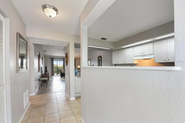 a view of a hallway with wooden shelves