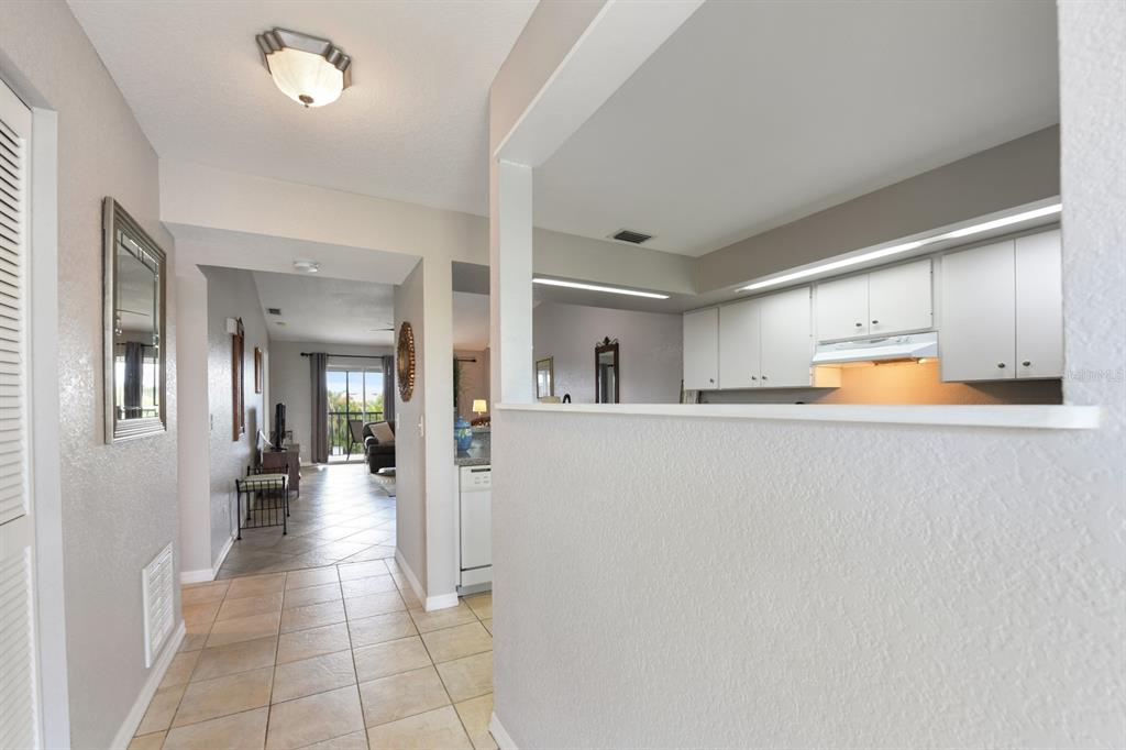 449 Royal Poinciana, Unit 221 Punta Gorda, FL 33955 - Photo 3 of 17 a view of a hallway with wooden shelves