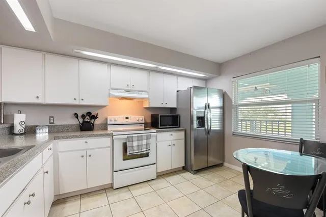 a kitchen with a sink cabinets and stainless steel appliances