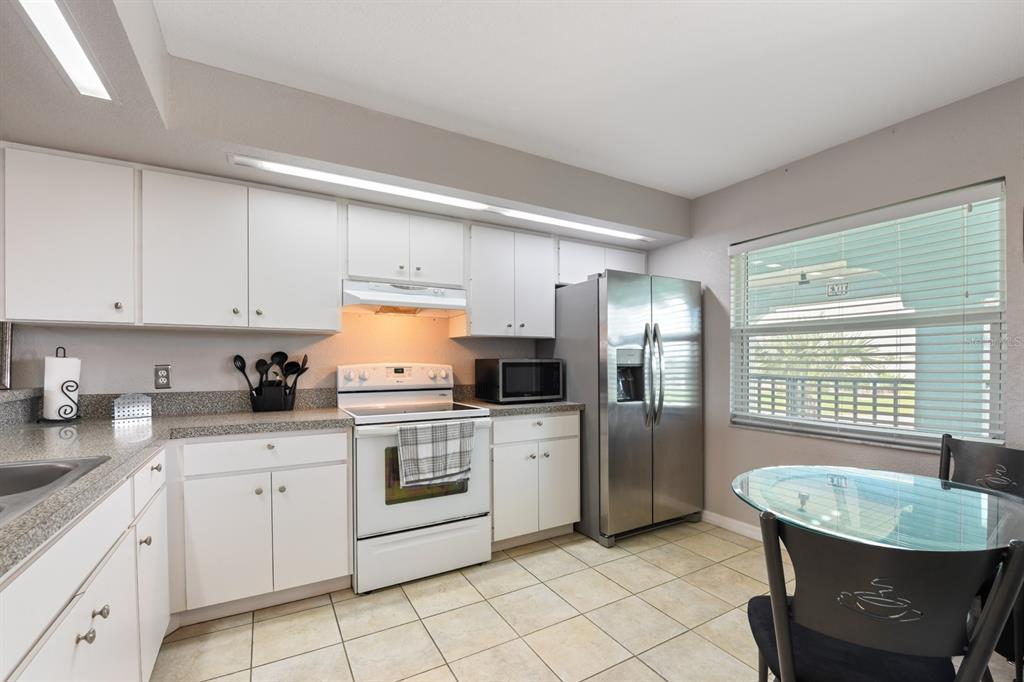 449 Royal Poinciana, Unit 221 Punta Gorda, FL 33955 - Photo 4 of 17 a kitchen with a sink cabinets and stainless steel appliances