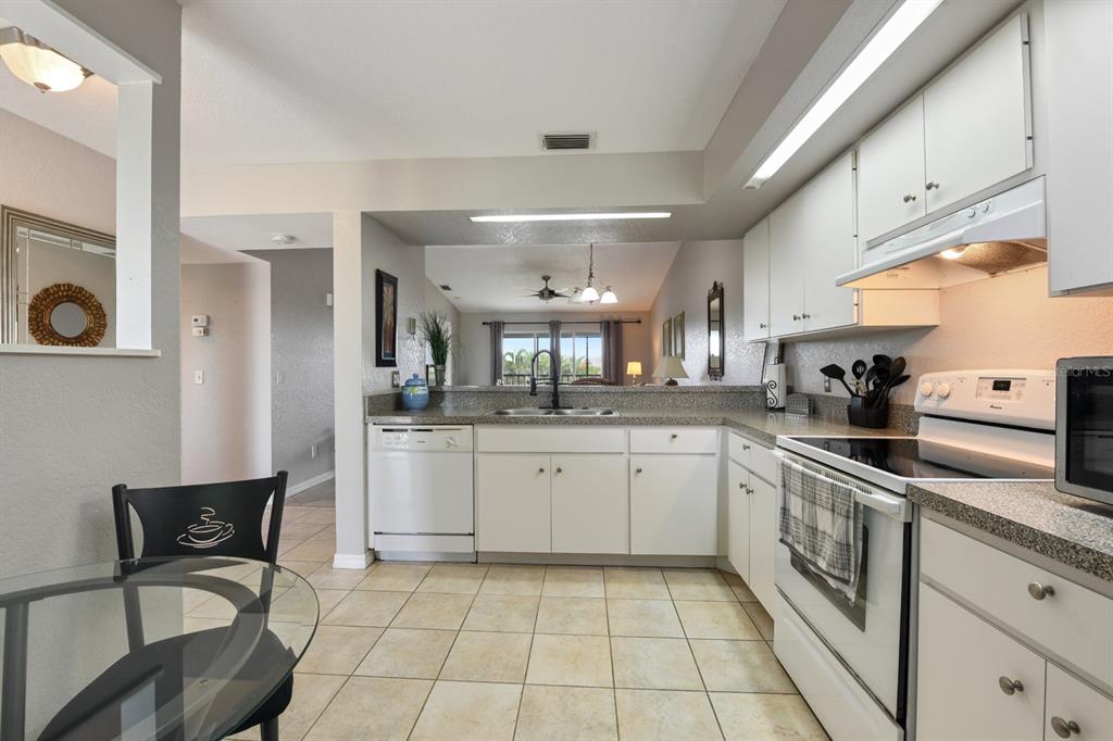 449 Royal Poinciana, Unit 221 Punta Gorda, FL 33955 - Photo 6 of 17 a kitchen with a sink and cabinets