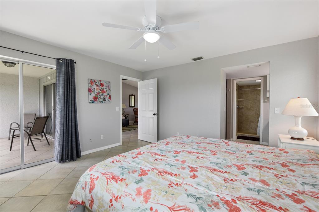 449 Royal Poinciana, Unit 221 Punta Gorda, FL 33955 - Photo 9 of 17 a bedroom with a bed and a chandelier