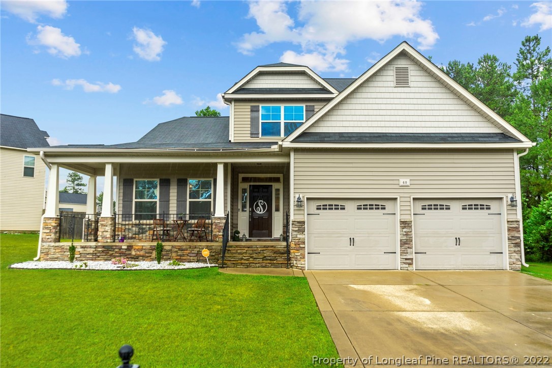 60 Shellbark Drive Spring Lake, NC 28390 - Photo 1 of 42 a front view of a house with a yard table and chairs